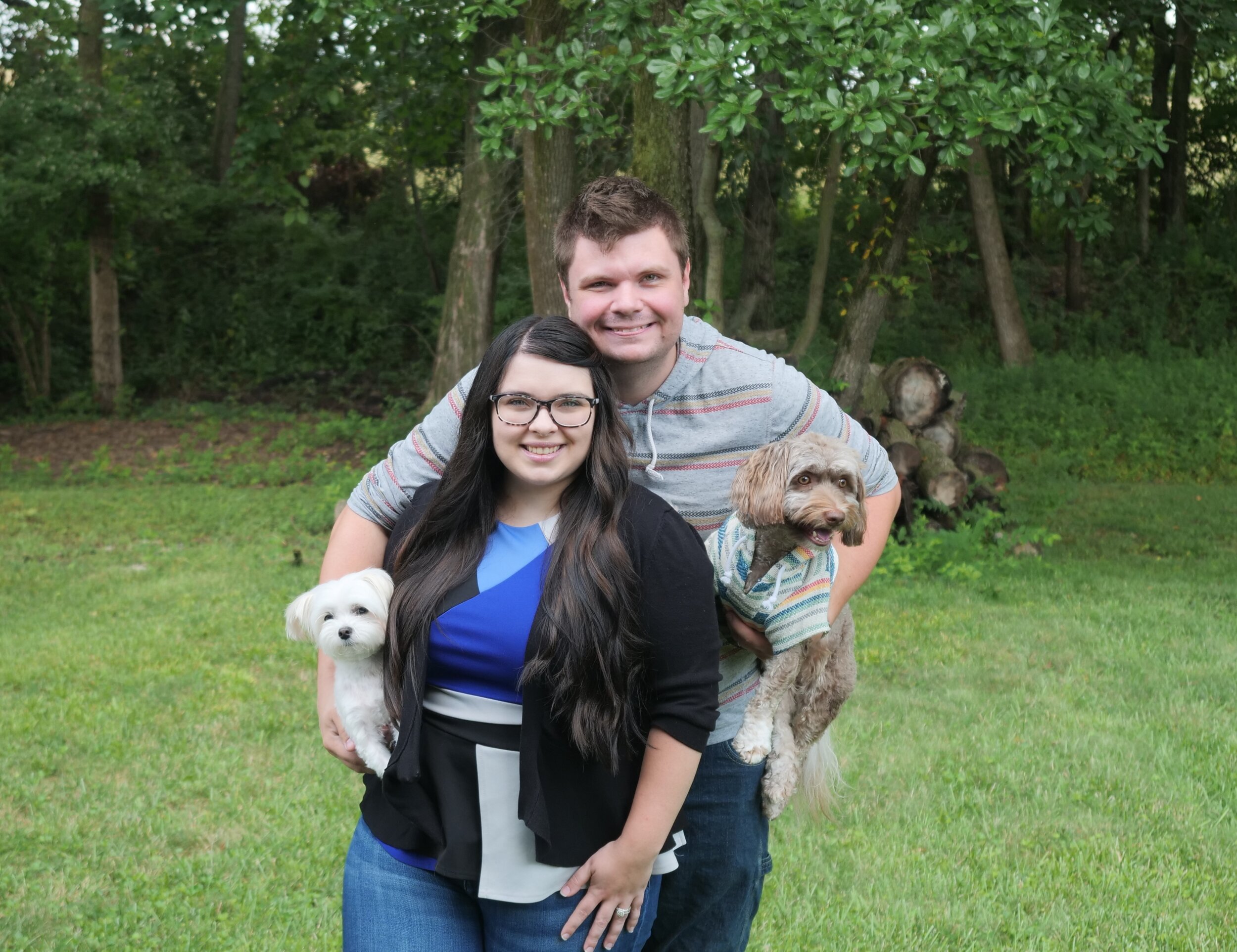 A family of two adults and two dogs